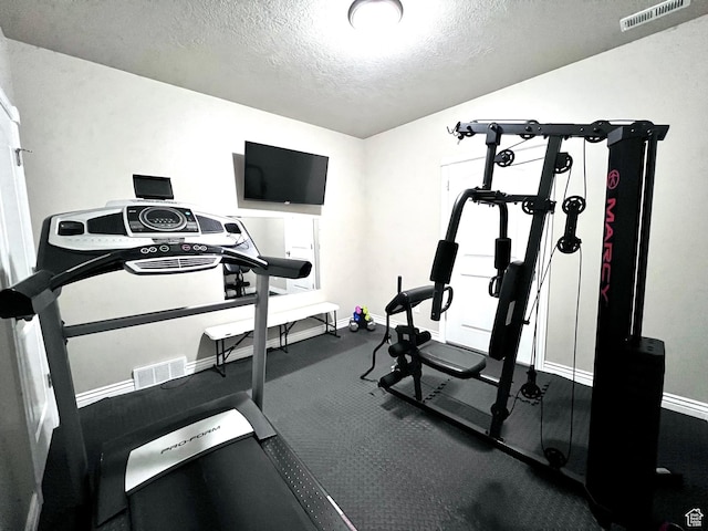 4433 Devonshire Dr W, Bountiful, UT 84010 - exercise area featuring a textured ceiling and baseboards