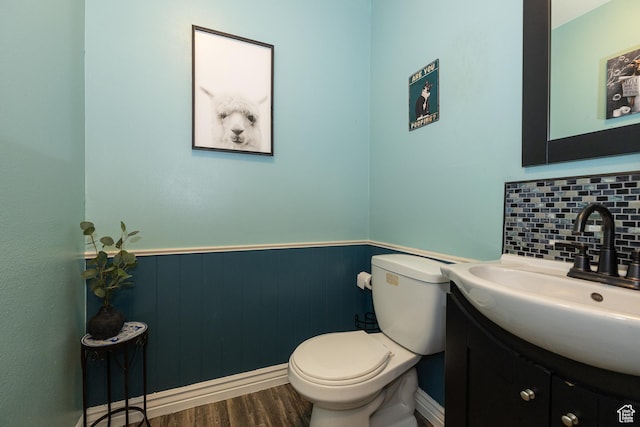 1250 N Lewis Peak Dr, Ogden, UT 84404 - half bath featuring vanity, toilet, a wainscoted wall, wood finished floors, and tasteful backsplash