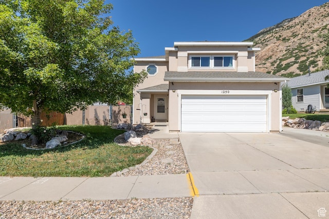 1250 N Lewis Peak Dr, Ogden, UT 84404 - view of front of home with driveway, stucco siding, an attached garage, and a mountain view