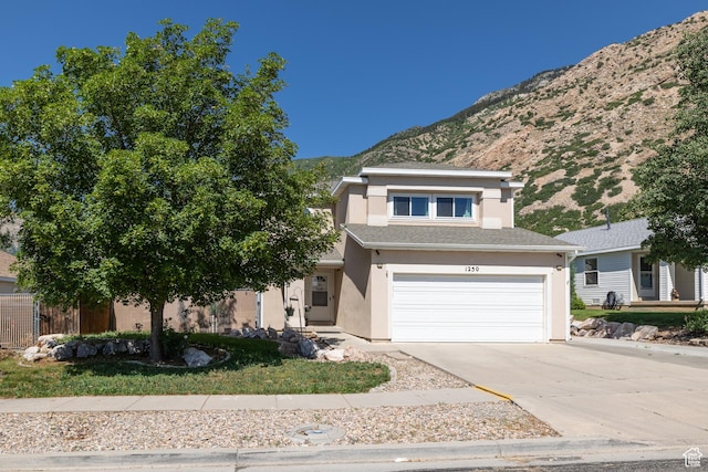 1250 N Lewis Peak Dr, Ogden, UT 84404 - view of front facade featuring a mountain view, stucco siding, concrete driveway, and a garage