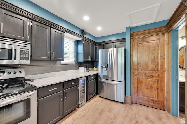 6767 S 1600 W, West Jordan, UT 84084 - kitchen with appliances with stainless steel finishes, beverage cooler, tasteful backsplash, light wood-style flooring, and light stone countertops
