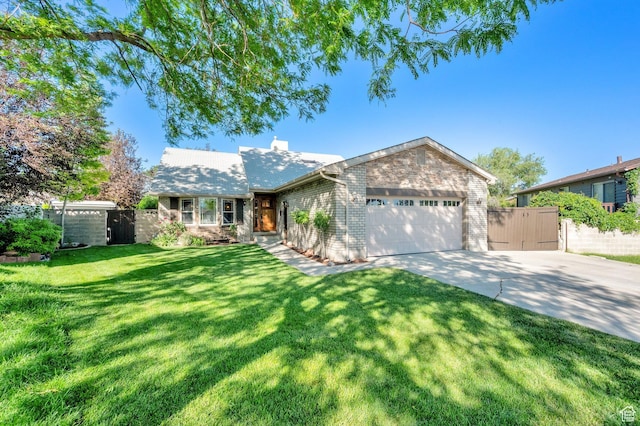 6767 S 1600 W, West Jordan, UT 84084 - view of front of property with driveway, an attached garage, a gate, a chimney, and brick siding