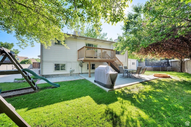 6767 S 1600 W, West Jordan, UT 84084 - back of property with a trampoline, a patio, a wooden deck, and stairs