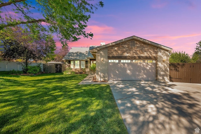 6767 S 1600 W, West Jordan, UT 84084 - view of front of house with brick siding, driveway, and a garage