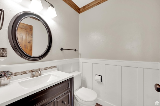 6767 S 1600 W, West Jordan, UT 84084 - half bathroom with toilet, wainscoting, vanity, a decorative wall, and ornamental molding