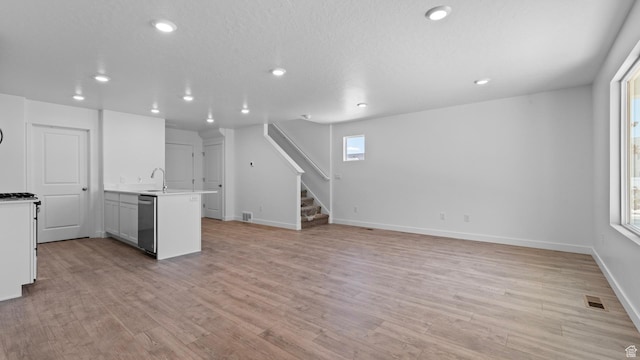 104 N Kelp Ln Unit 2310, Saratoga Springs, UT 84045 - kitchen featuring stainless steel dishwasher, recessed lighting, healthy amount of natural light, and light wood-type flooring