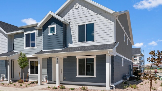 104 N Kelp Ln Unit 2310, Saratoga Springs, UT 84045 - view of front of home featuring covered porch, roof with shingles, and central air condition unit