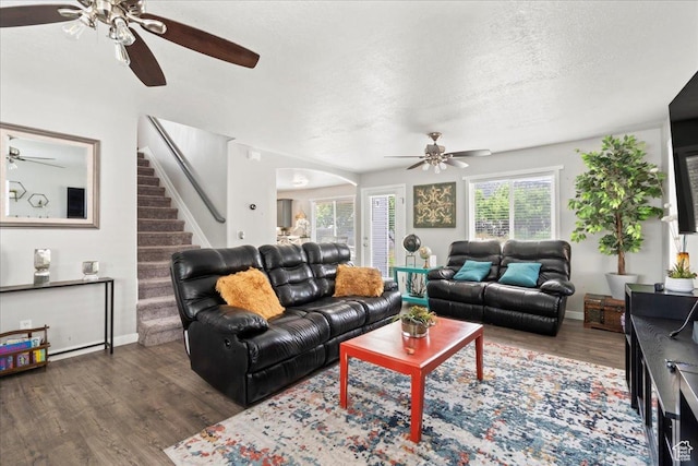 7265 N Ute Dr, Eagle Mountain, UT 84005 - living area with ceiling fan, wood finished floors, stairway, arched walkways, and a textured ceiling