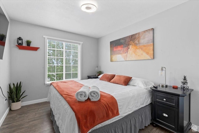 7265 N Ute Dr, Eagle Mountain, UT 84005 - bedroom featuring dark wood-style floors and baseboards