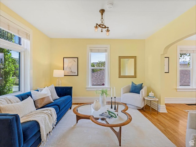 218 E Fifth Ave, Salt Lake City, UT 84103 - living area featuring wood finished floors, arched walkways, and baseboards