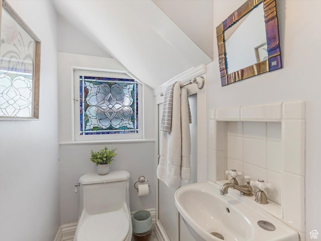 218 E Fifth Ave, Salt Lake City, UT 84103 - half bathroom featuring toilet, vaulted ceiling, and baseboards