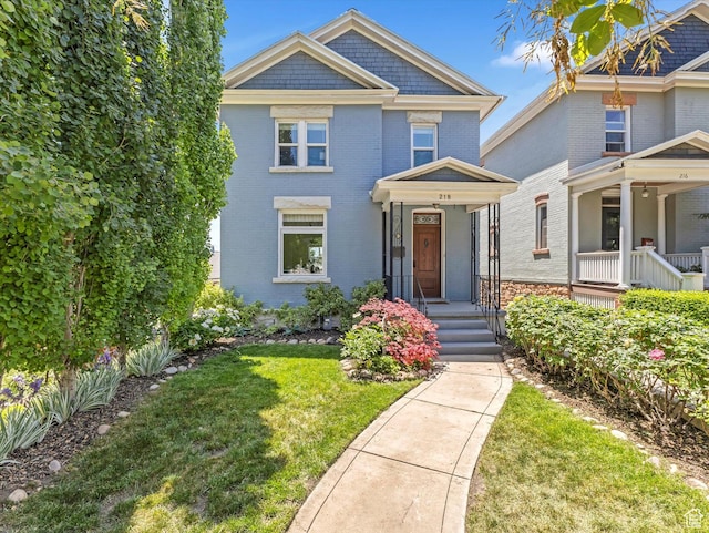 218 E Fifth Ave, Salt Lake City, UT 84103 - view of front of property featuring a front yard and brick siding