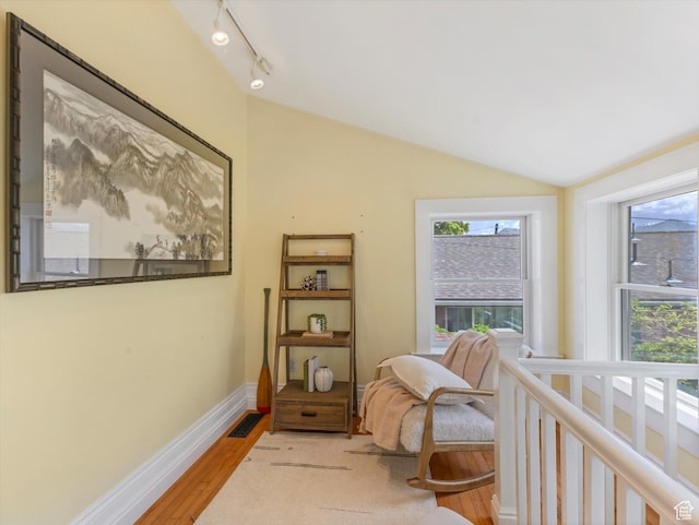 218 E Fifth Ave, Salt Lake City, UT 84103 - living area featuring plenty of natural light, vaulted ceiling, light wood-type flooring, track lighting, and baseboards