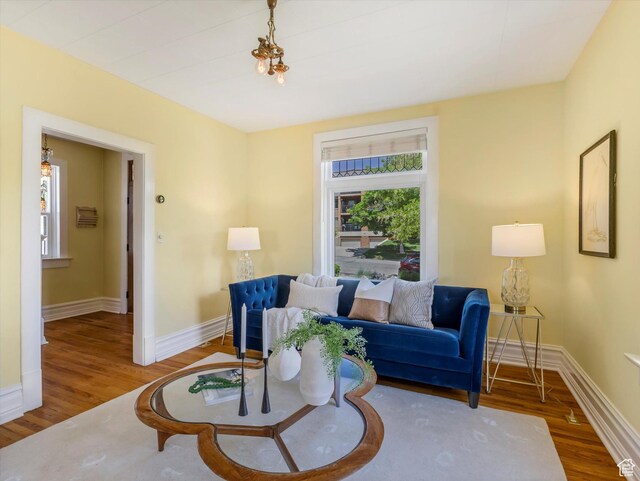 218 E Fifth Ave, Salt Lake City, UT 84103 - living room with healthy amount of natural light, wood finished floors, and baseboards