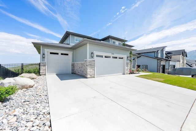 2279 E Ravine Rock Way, Draper, UT 84020 - view of home's exterior featuring a garage, driveway, and stone siding