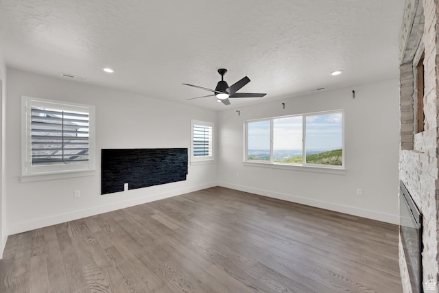 2279 E Ravine Rock Way, Draper, UT 84020 - unfurnished living room with a ceiling fan, baseboards, wood finished floors, recessed lighting, and a textured ceiling