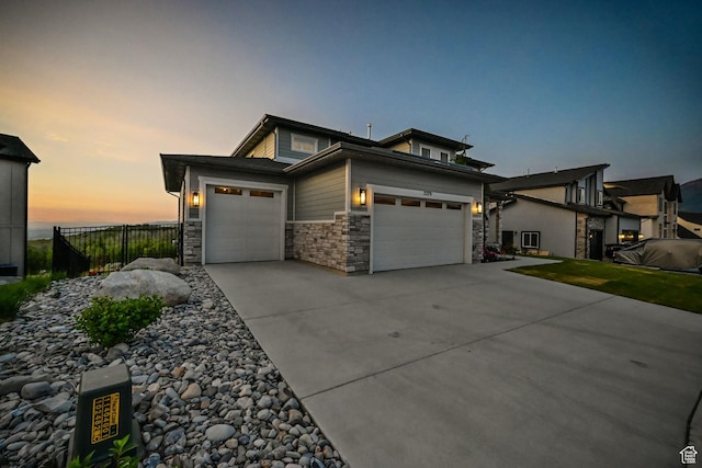 2279 E Ravine Rock Way, Draper, UT 84020 - view of front facade featuring a garage, stone siding, and concrete driveway