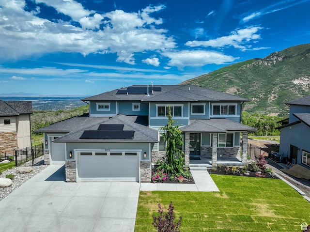 2279 E Ravine Rock Way, Draper, UT 84020 - prairie-style house with roof mounted solar panels, an attached garage, concrete driveway, and stone siding