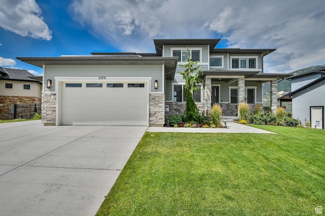 2279 E Ravine Rock Way, Draper, UT 84020 - prairie-style house featuring concrete driveway, a front yard, an attached garage, and stone siding