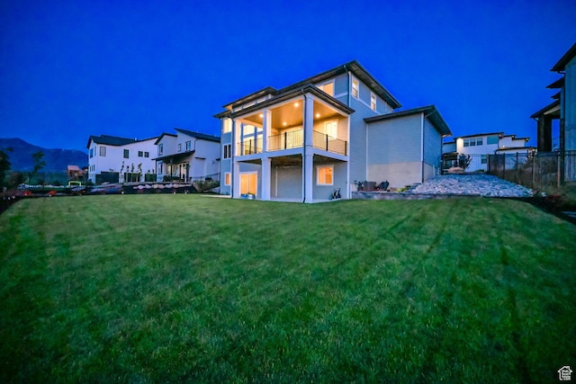 2279 E Ravine Rock Way, Draper, UT 84020 - back of house at night featuring a balcony