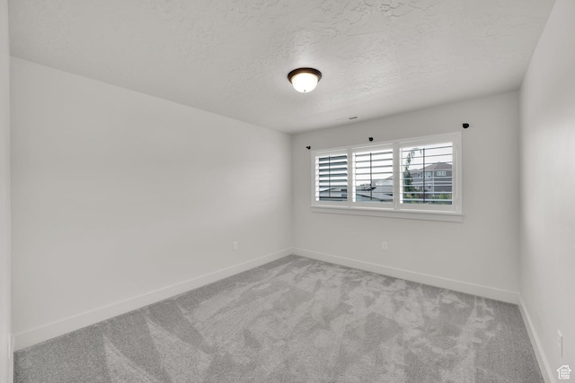 2279 E Ravine Rock Way, Draper, UT 84020 - spare room featuring carpet flooring, baseboards, and a textured ceiling