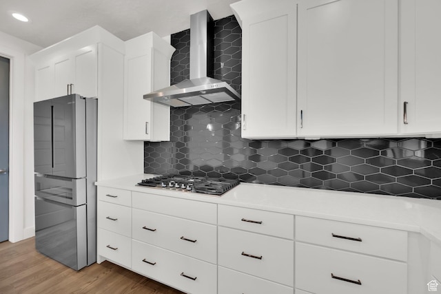 2279 E Ravine Rock Way, Draper, UT 84020 - kitchen with wall chimney exhaust hood, appliances with stainless steel finishes, white cabinets, backsplash, and recessed lighting