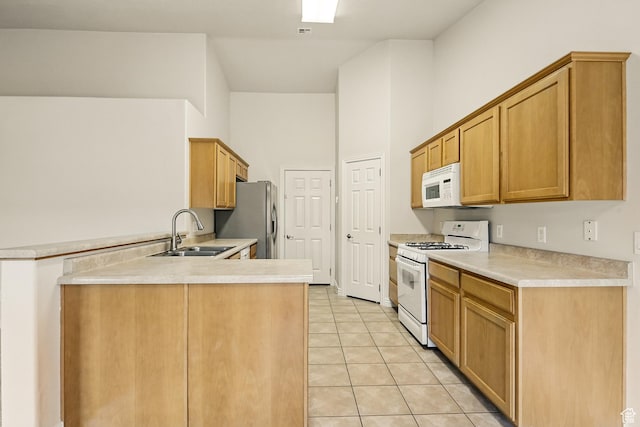 1447 S Southern View Dr, Cedar City, UT 84720 - kitchen with white appliances, a sink, a peninsula, light countertops, and a high ceiling