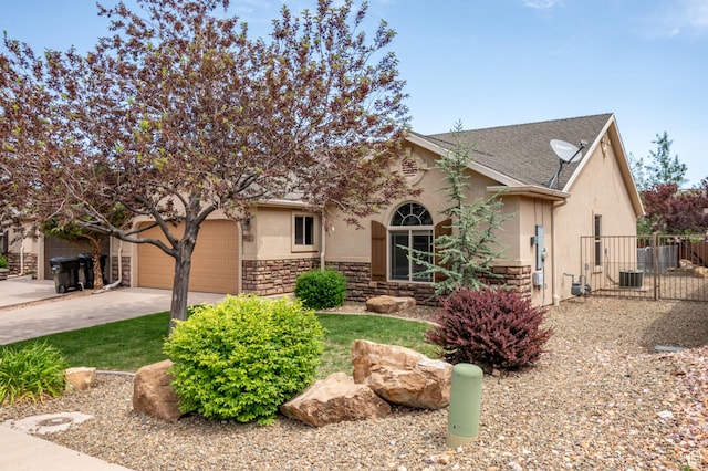 1447 S Southern View Dr, Cedar City, UT 84720 - view of property hidden behind natural elements featuring stucco siding, stone siding, driveway, roof with shingles, and an attached garage