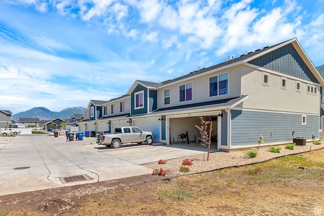 1323 S 3540 E, Spanish Fork, UT 84660 - back of house featuring a garage, a residential view, concrete driveway, and board and batten siding