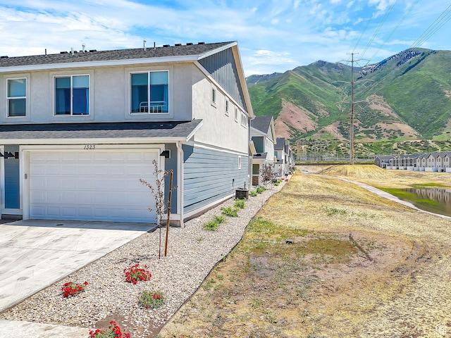 1323 S 3540 E, Spanish Fork, UT 84660 - view of property exterior featuring a mountain view, an attached garage, and concrete driveway