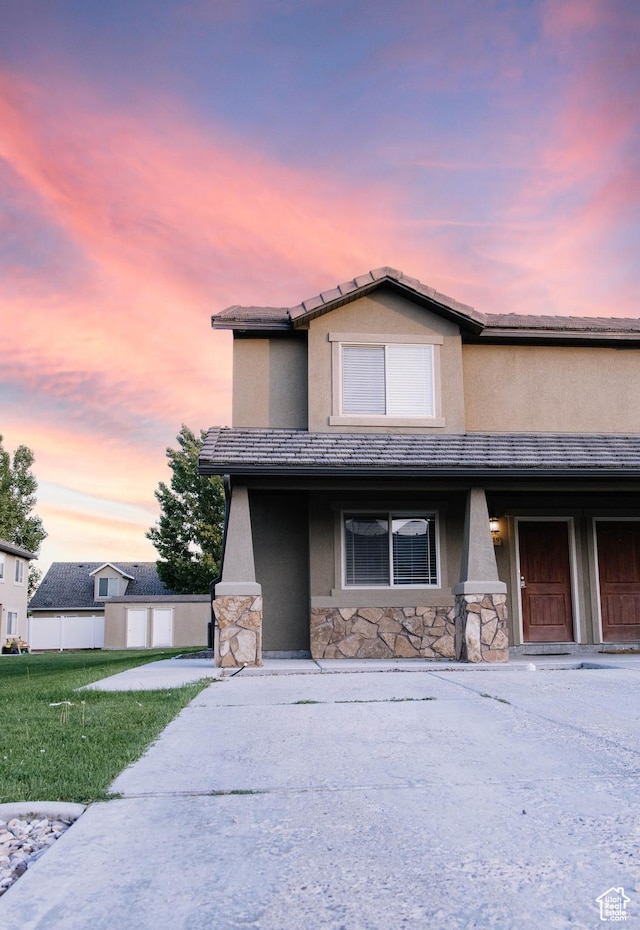 119 W 700 N, Vernal, UT 84078 - view of front of property featuring stone siding, stucco siding, a yard, and covered porch