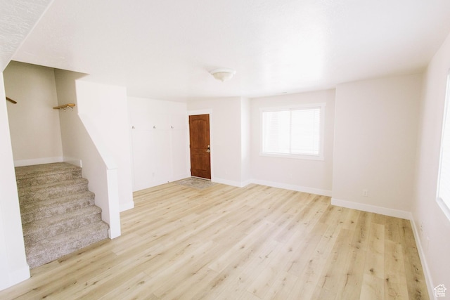 119 W 700 N, Vernal, UT 84078 - unfurnished living room featuring stairway, wood finished floors, and baseboards