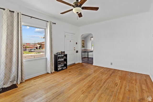 105 N 100 W, Richfield, UT 84701 - spare room featuring ceiling fan, arched walkways, light wood-type flooring, and baseboards