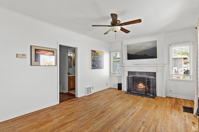 105 N 100 W, Richfield, UT 84701 - unfurnished living room with a premium fireplace, light wood-type flooring, and healthy amount of natural light