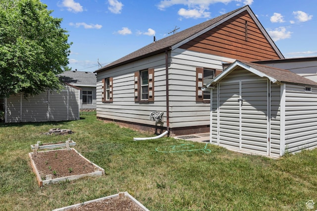 105 N 100 W, Richfield, UT 84701 - view of side of property with a garden, a lawn, and a shingled roof