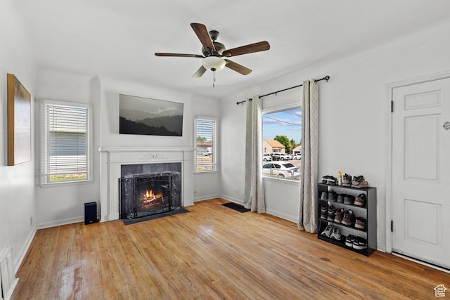 105 N 100 W, Richfield, UT 84701 - living room with a fireplace, ceiling fan, wood finished floors, and baseboards