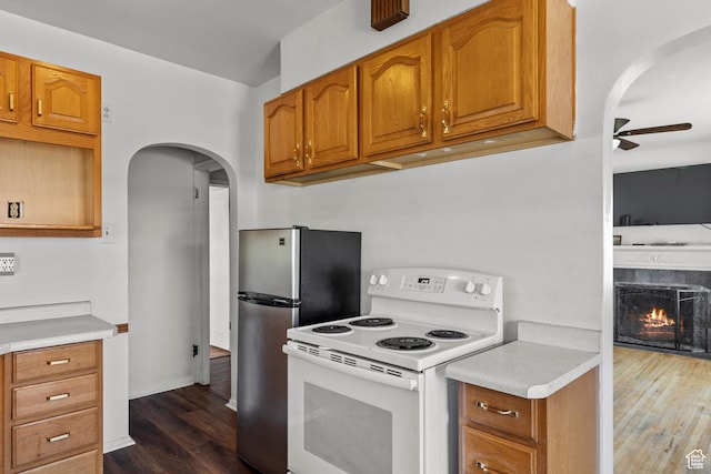 105 N 100 W, Richfield, UT 84701 - kitchen with white range with electric cooktop, arched walkways, a ceiling fan, dark wood-style flooring, and light countertops