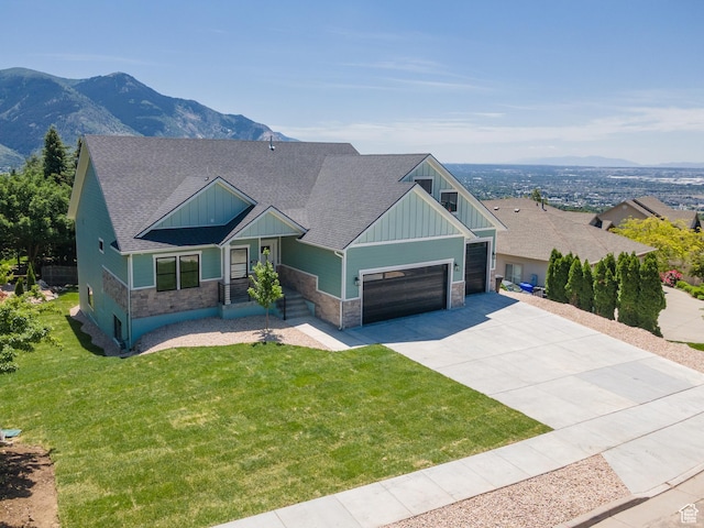 3616 N 600 E, North Ogden, UT 84414 - craftsman house featuring board and batten siding, stone siding, an attached garage, concrete driveway, and a front yard