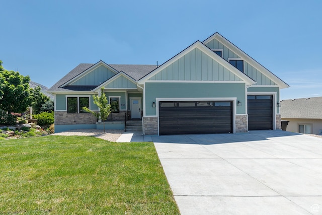 3616 N 600 E, North Ogden, UT 84414 - craftsman house with board and batten siding, an attached garage, concrete driveway, a front lawn, and stone siding