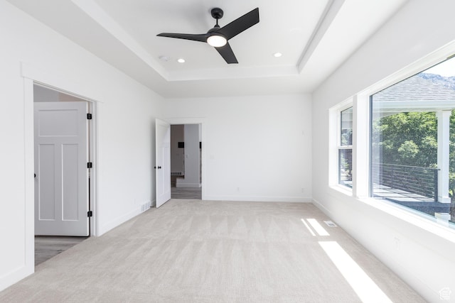 3616 N 600 E, North Ogden, UT 84414 - unfurnished bedroom featuring light carpet, a tray ceiling, baseboards, ceiling fan, and recessed lighting