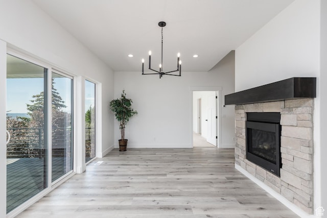 3616 N 600 E, North Ogden, UT 84414 - unfurnished living room featuring light wood-type flooring, a chandelier, recessed lighting, a fireplace, and baseboards