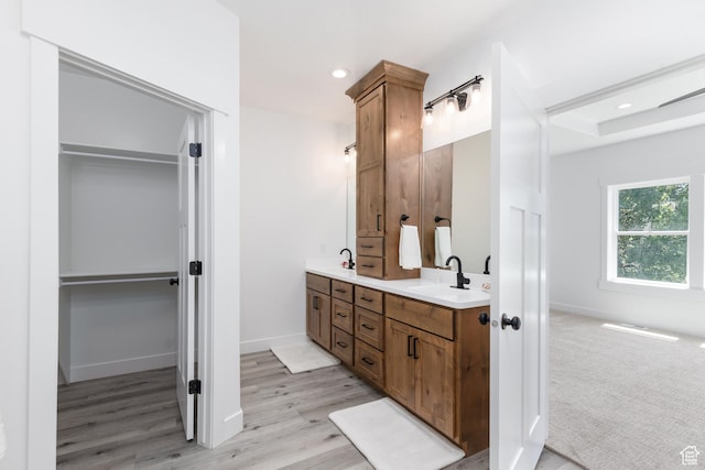 3616 N 600 E, North Ogden, UT 84414 - bathroom featuring double vanity, a walk in closet, wood finished floors, baseboards, and recessed lighting
