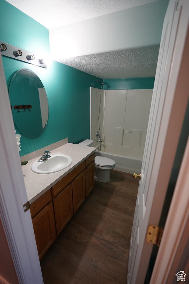 2881 N 450 E, North Ogden, UT 84414 - full bath with wood finished floors, vanity, a textured ceiling, toilet, and shower / bath combination