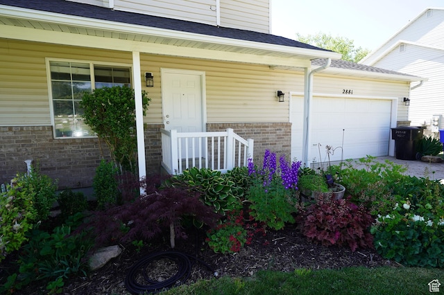 2881 N 450 E, North Ogden, UT 84414 - property entrance featuring brick siding, an attached garage, roof with shingles, and a porch