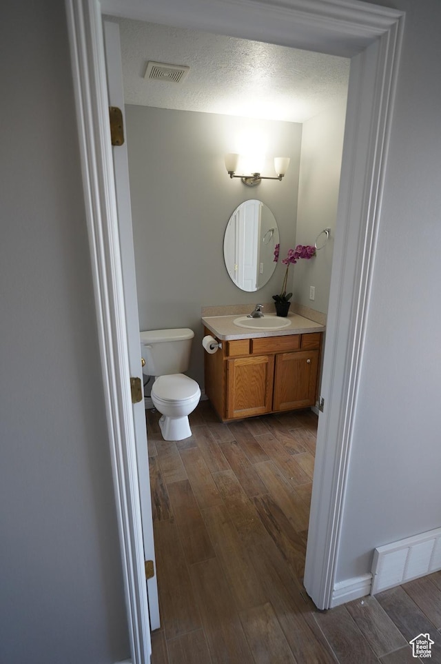 2881 N 450 E, North Ogden, UT 84414 - bathroom featuring wood finished floors, vanity, and toilet