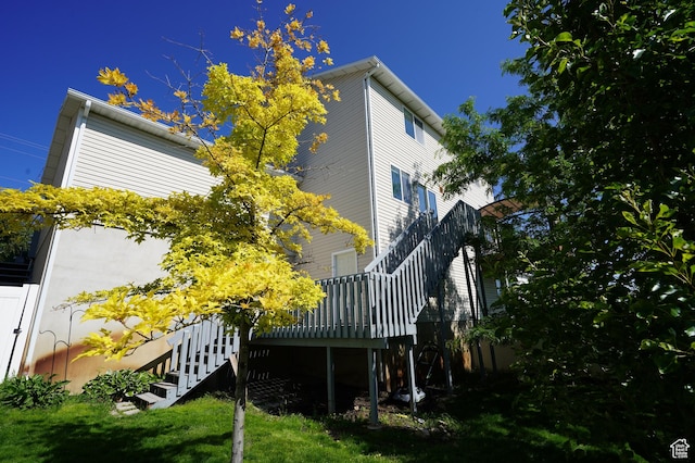 2881 N 450 E, North Ogden, UT 84414 - view of side of home featuring stairway, a wooden deck, and a lawn