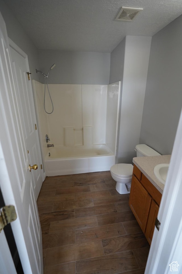 2881 N 450 E, North Ogden, UT 84414 - bathroom with vanity, wood finished floors, toilet, bathtub / shower combination, and a textured ceiling