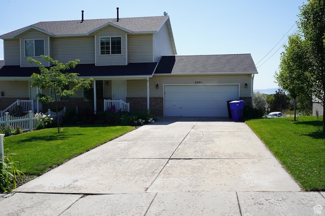 2881 N 450 E, North Ogden, UT 84414 - traditional home featuring a garage, brick siding, concrete driveway, and a front yard