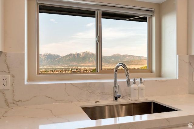 14709 S Cedar Knoll Cir, Herriman, UT 84096 - kitchen view of a sink, tasteful backsplash, light stone counters, and mountains