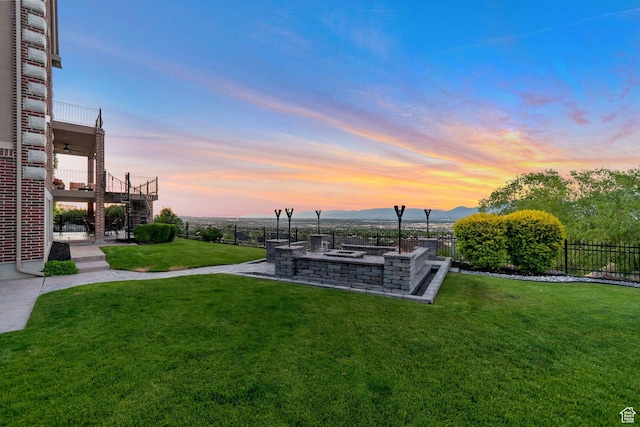 14709 S Cedar Knoll Cir, Herriman, UT 84096 - yard at dusk featuring an outdoor fire pit, a mountain view, and a balcony